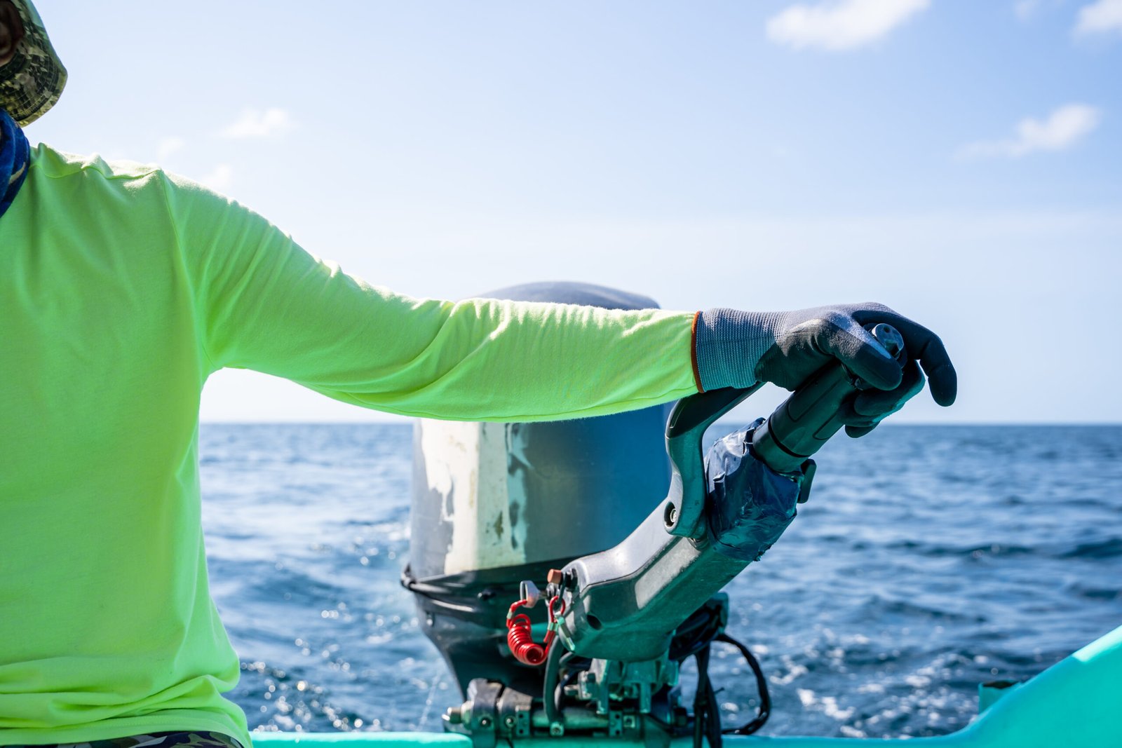 unrecognizable person driving a motorboat along the sea